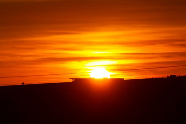 Sunset directly over the grandstand at Brighton racecourse